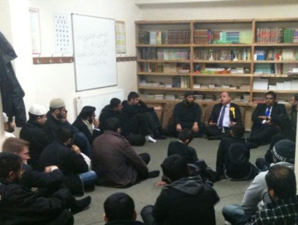 Elwyn Watkins and Kashif Ali answer questions in Oldham's Glodwick community centre