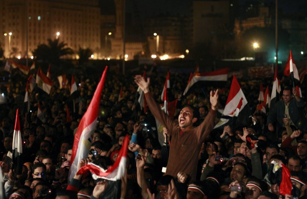 Protestors hold  up a sign saying 'the army and the people are one'