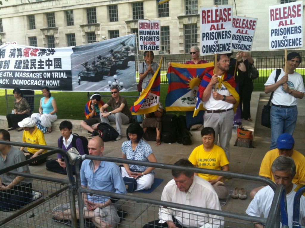 Free Tibet demonstrators meditate outside Downing Street during David Cameron's press conference with Wen Jiabao.