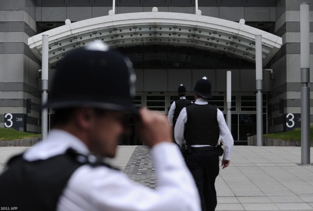 Police officers outside News International at the height of the scandal.