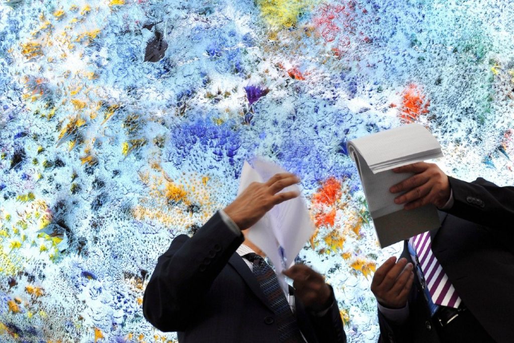 Delegates check their papers beneath a painted ceiling ahead of a UN Human Rights Council meeting on Syria earlier this month.