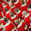 Members of the House of Lords wait for the Queen at the state opening of parliament