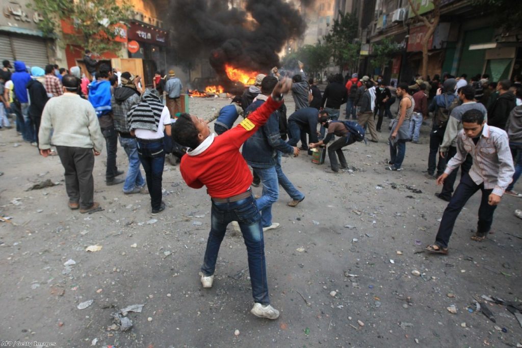 A young protestor during a demonstration in Egypt during the Arab Spring. David Cameron was criticised for travelling to the country with arms dealers after the revolution.