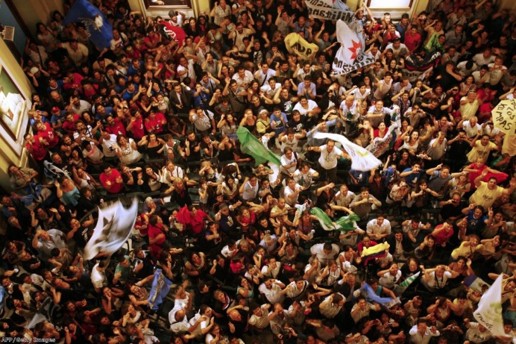 Crowds outside the presidential house. Argentina's president is enjoying a wave of popularity after having her thyroid gland removed.