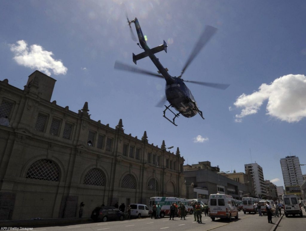 A helicopter transports injured people to a medical center after a train crashed at Once train station in Buenos Aires.