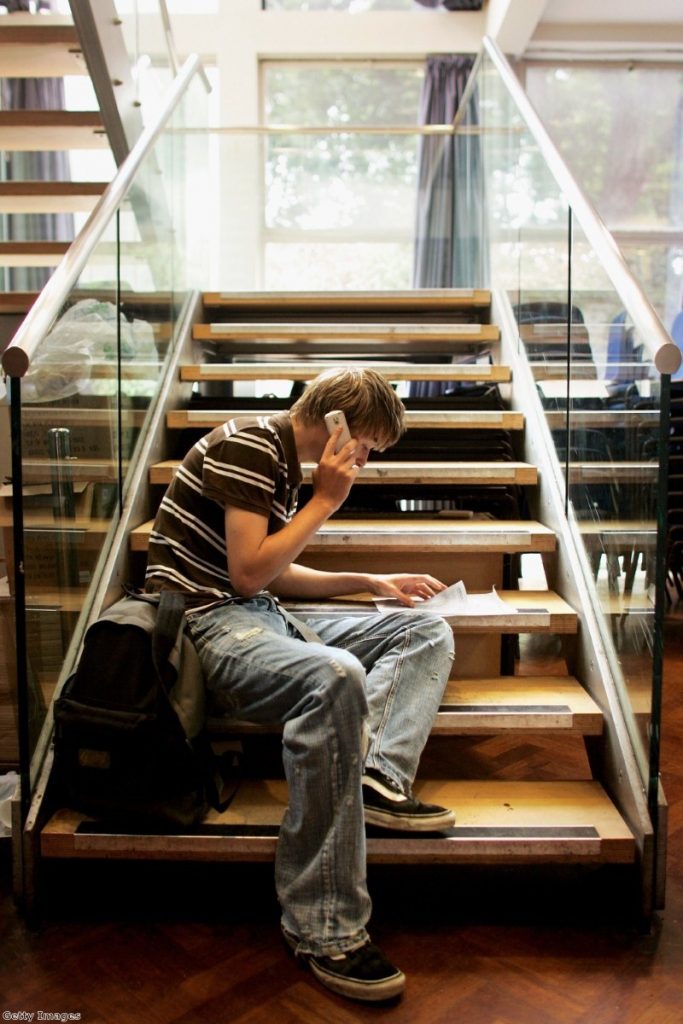 A GCSE students reads out his results on the phone. Many will be disappointed with their grades after a mew system was introduced.