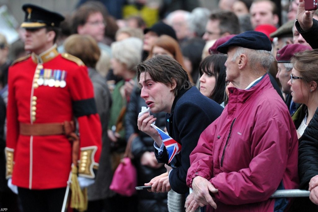 A mourner weeps as Margaret Thatcher