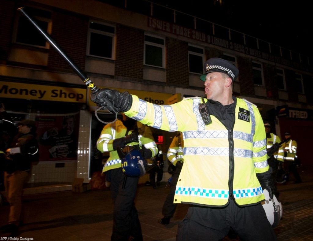 Police charge to disperse demonstrators in Woolich last night after a man believed to be a serving British soldier was brutally murdered nearby