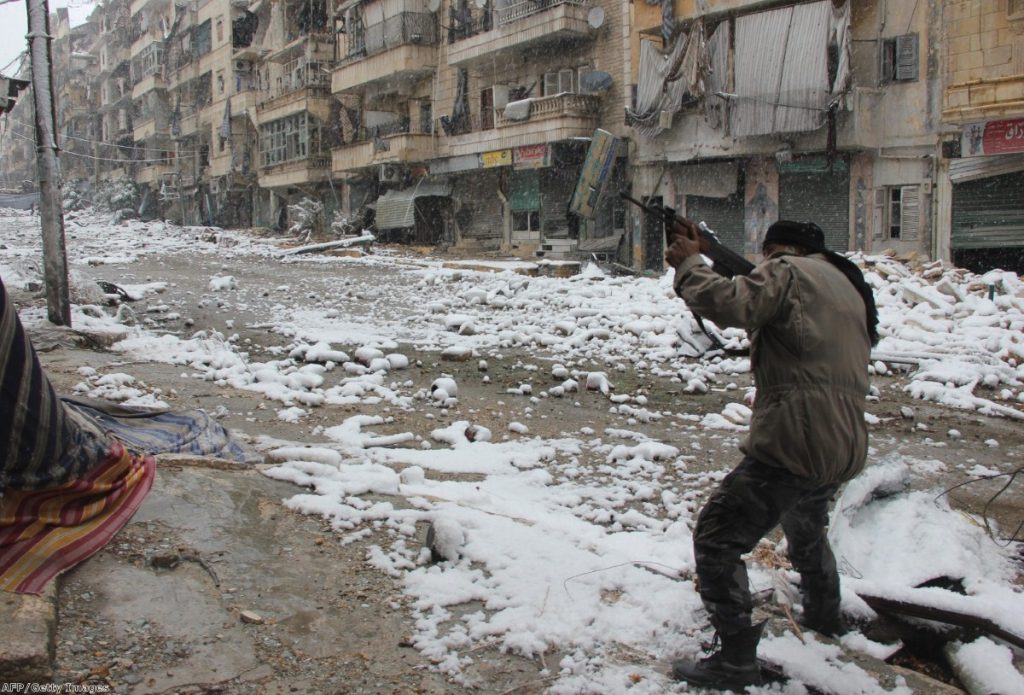 A rebel fighter aims his weapon during clashes with Syrian pro-government forces in the Salaheddin neighbourhood of Aleppo in 2013 