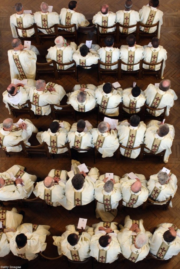 Priests wear their new clerical vestments during the annual Chrism Mass in Westminster Cathedral. The Church's insistence on a compassionate response to immigration is coming into conflict with tough rhetoric from the government.