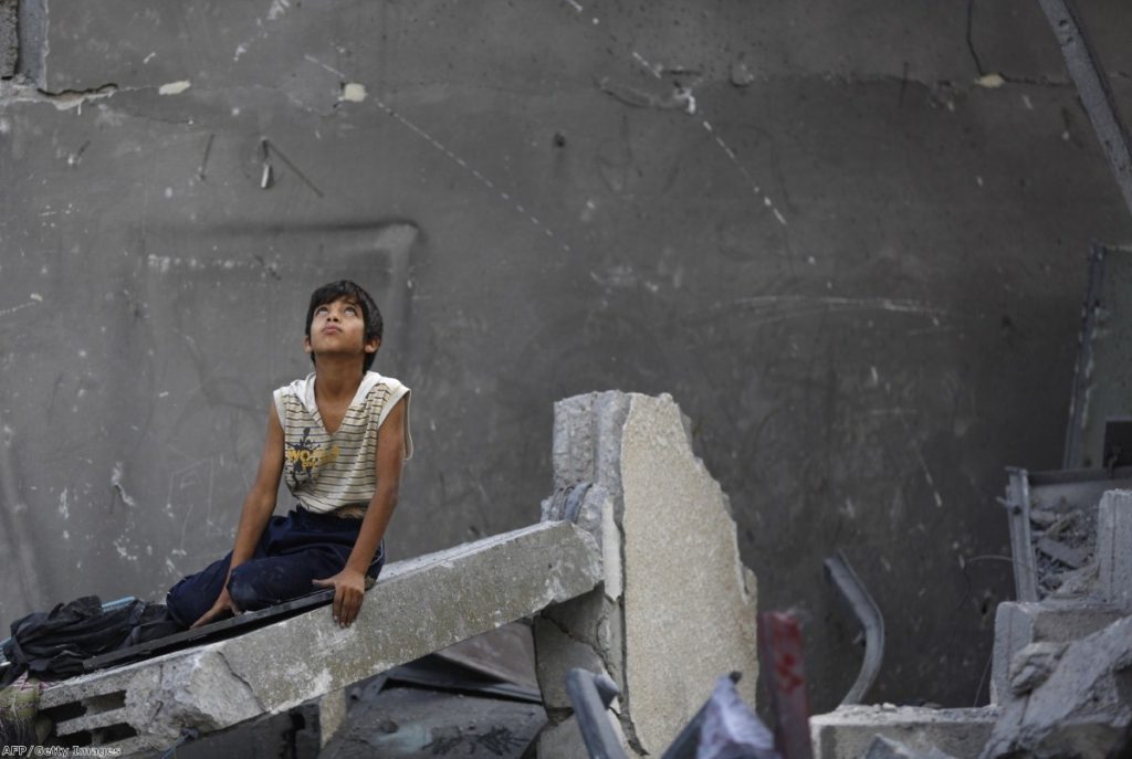  Palestinian boy sits on the rubble of a destroyed building following an Israeli air strike earlier today. Air strikes killed at least seven people in Gaza, including five members of the same family, an emergency services spokesman said. 