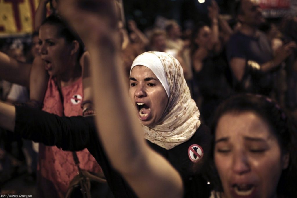 A protester shouts slogans outside the US embassy in Athens during a demonstration against Israel's offensive in the Gaza Strip on Thursday