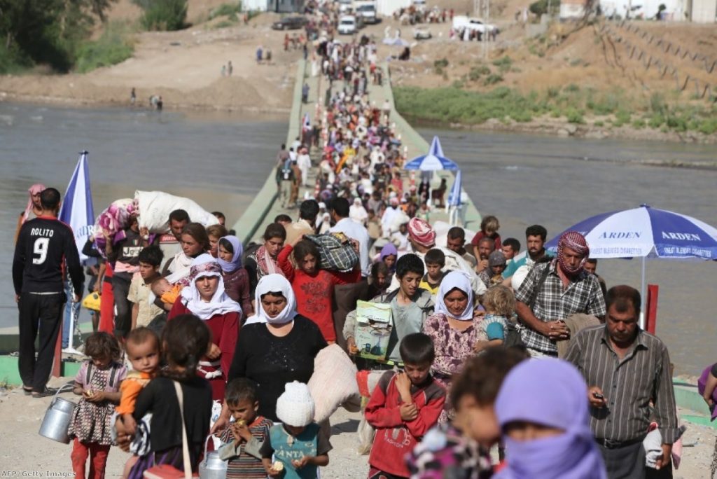 Yazidis flee unrest in northern Iraq, where around one million people have been displaced