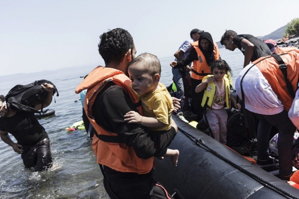 Migrants arrive on a beach of the Greek island of Lesbos, after crossing, on an inflatable boat with 35 people