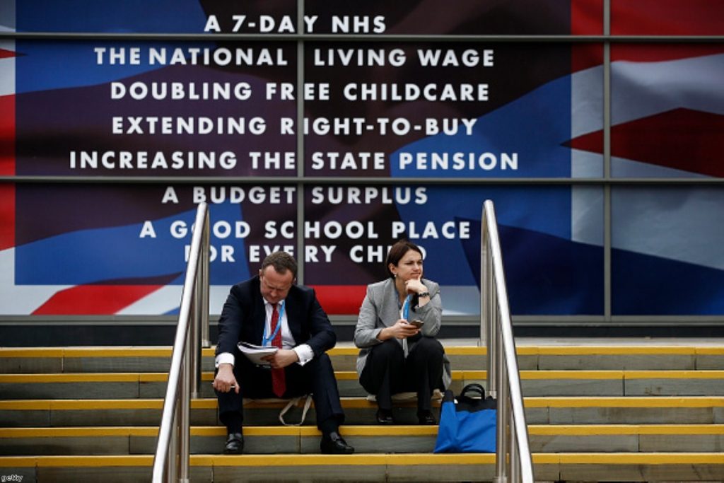 Delegates take a break outside the Conservative Party's annual conference in Manchester on Monday