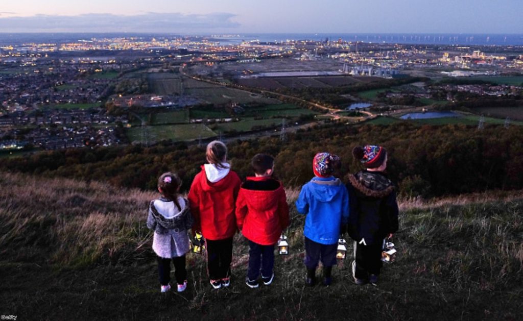 Children stand with lanterns during a torch-lit procession on the top of the Eston Hills overlooking Teesside