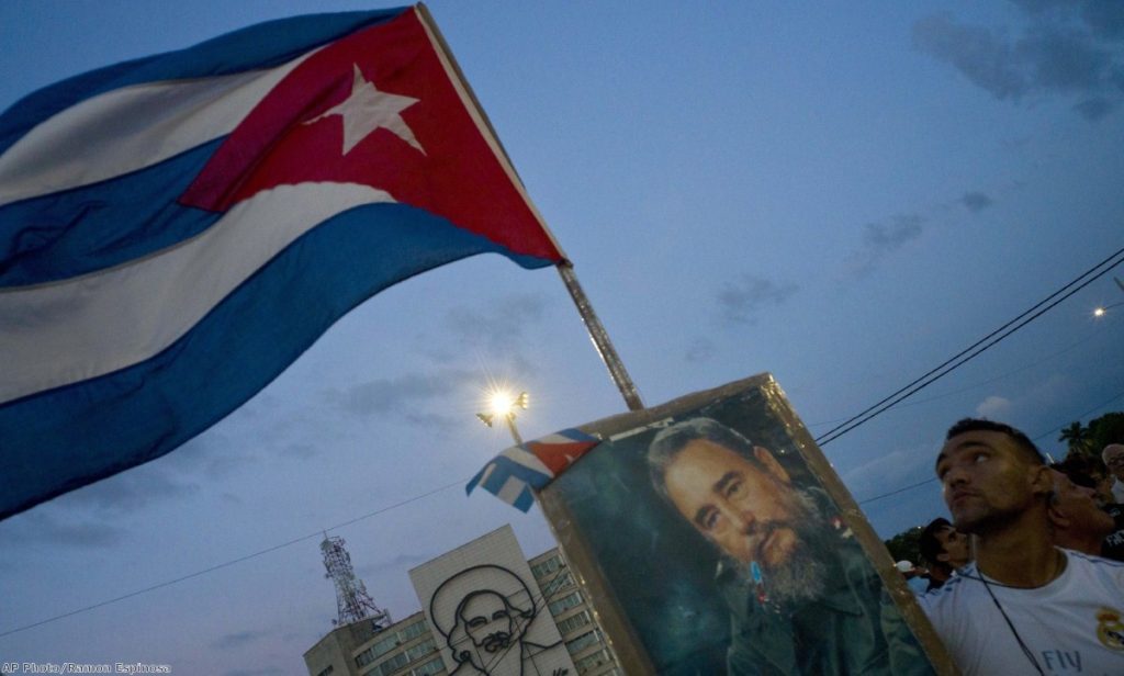 A man holds a portrait of Fidel Castro during a rally honoring the deceased Cuban leader at the Revolution Plaza in Havana