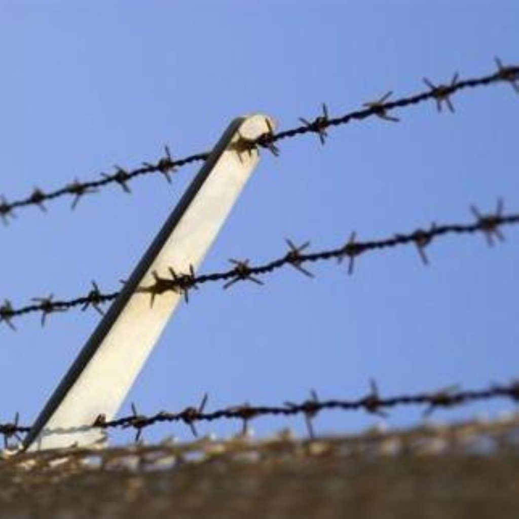 Barbed wire over a wall