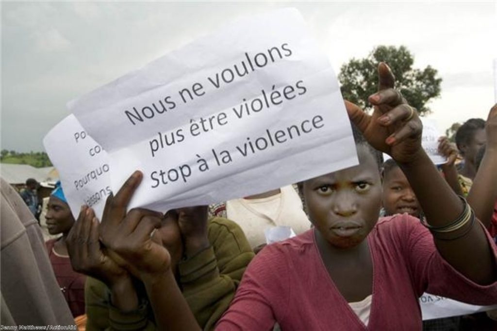 A woman holds up a sign at the protest