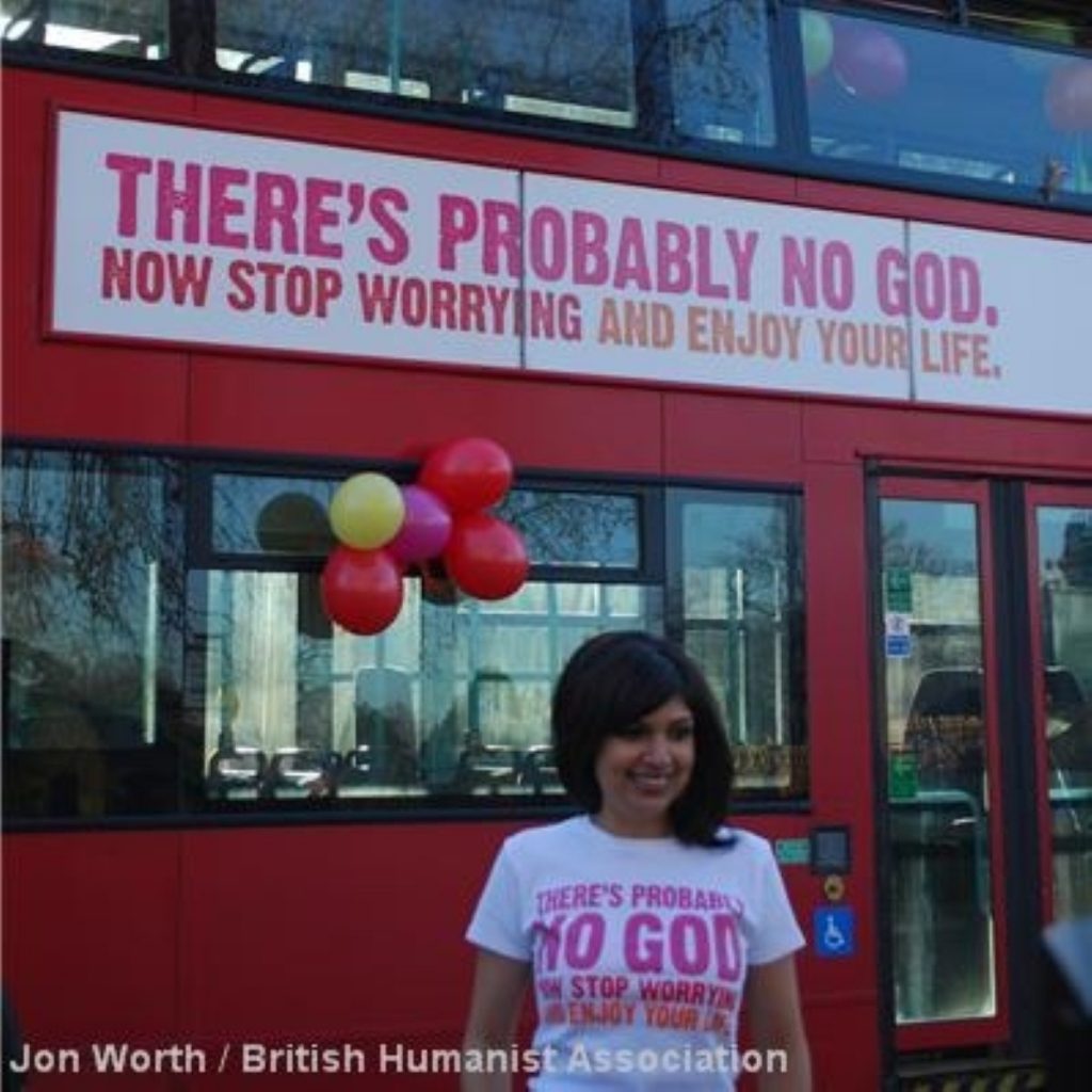 Ariane Sherine, the founder of the campaign, by one of the buses