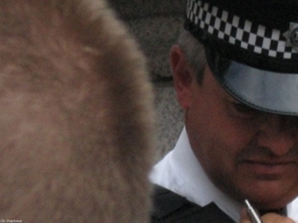 A policeman watches a demonstrator