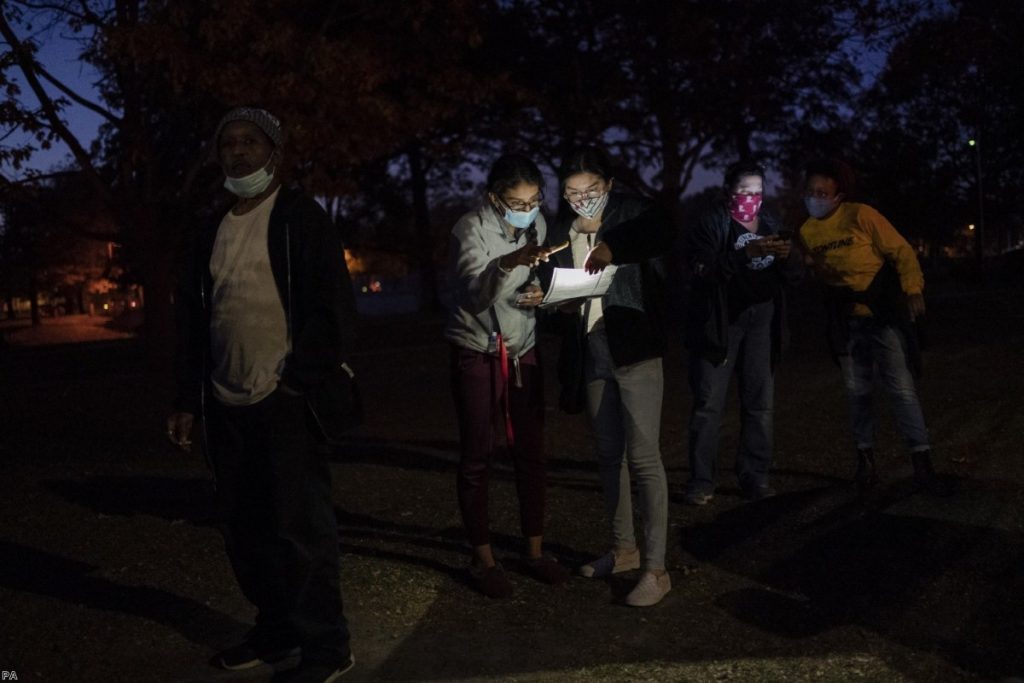 Voters wait in line at a polling centre on election day in Kenosha, Wisconsin. Opinion polls in the weeks ahead of the vote hugely overestimated Biden's support.