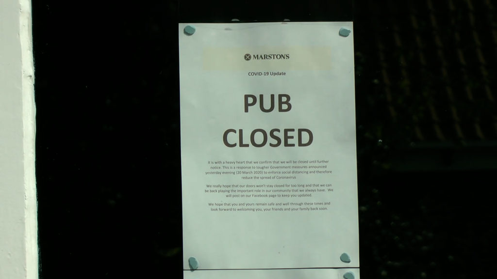 A notice in a window saying "PUB CLOSED"