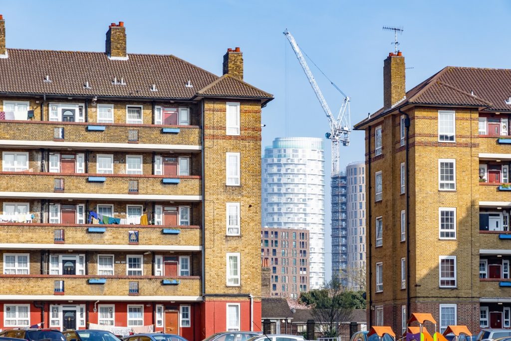 Council housing blocks contrasted with modern high-rise flats