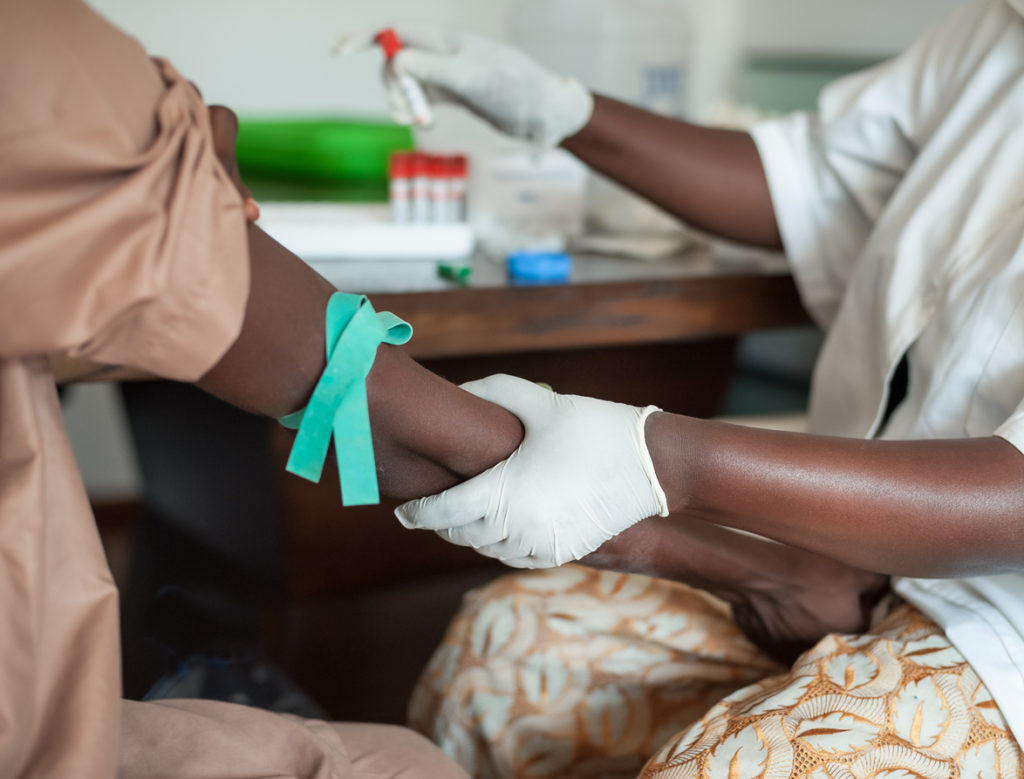 African nurse is drawing blood