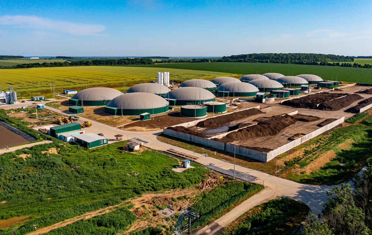 Biogas station at the green large field. Distillation process is used to produce bio gas at station.