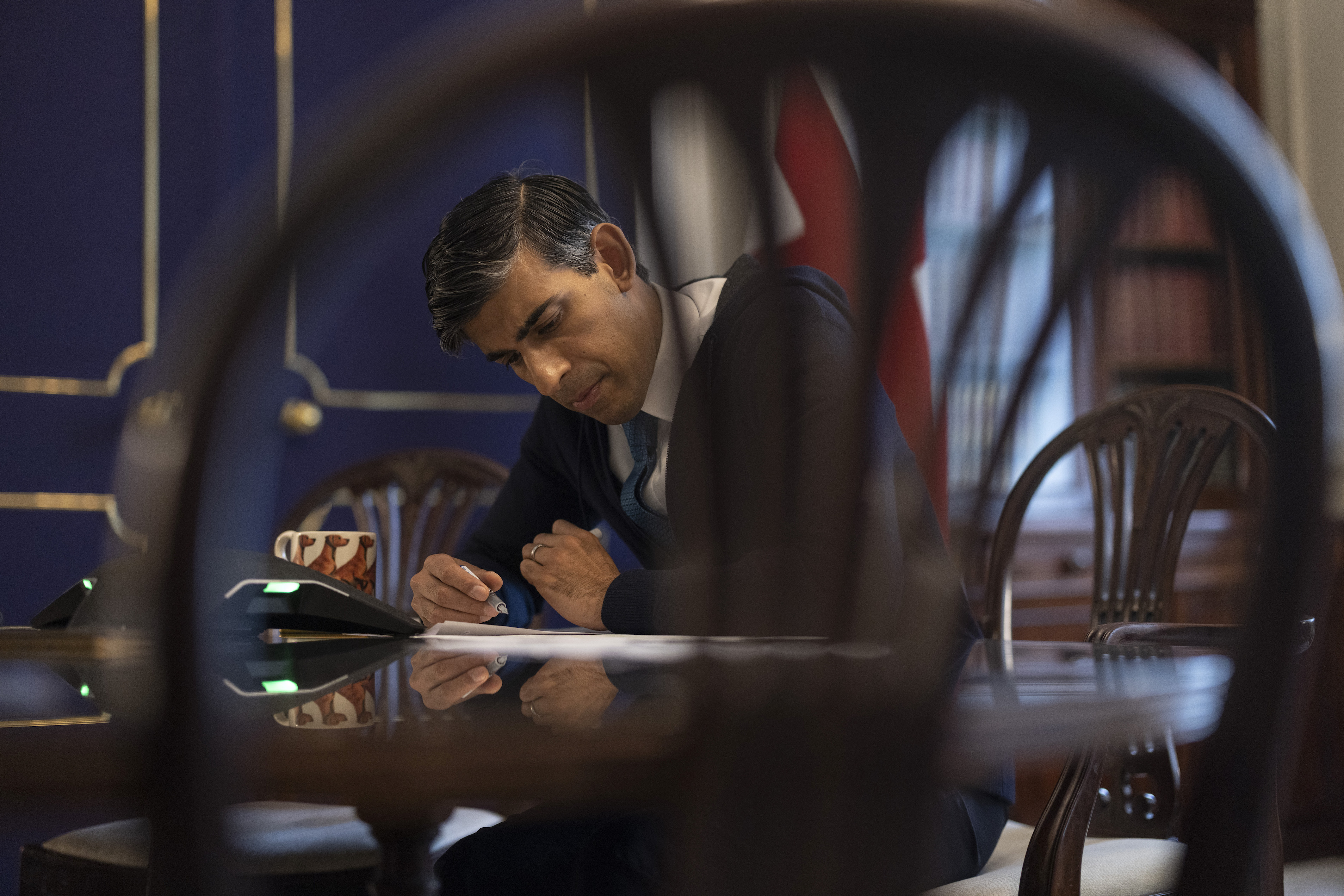 Prime Minister Rishi Sunak at his desk in Downing Street as his popularity sinks.
